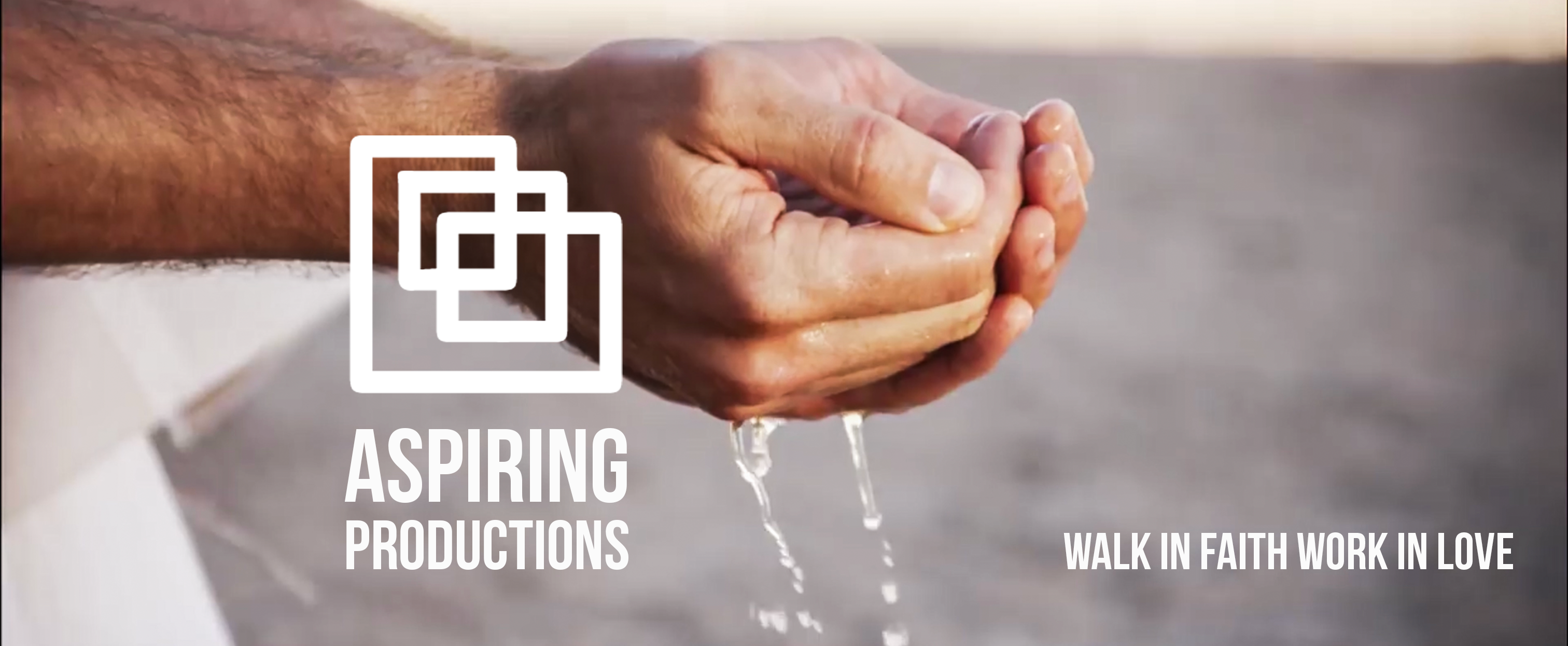 an older man's hands lifting water 